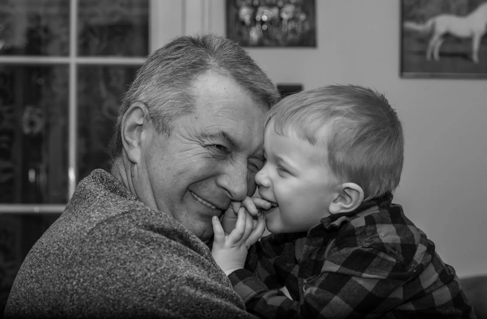 grayscale photo of man kissing womans cheek